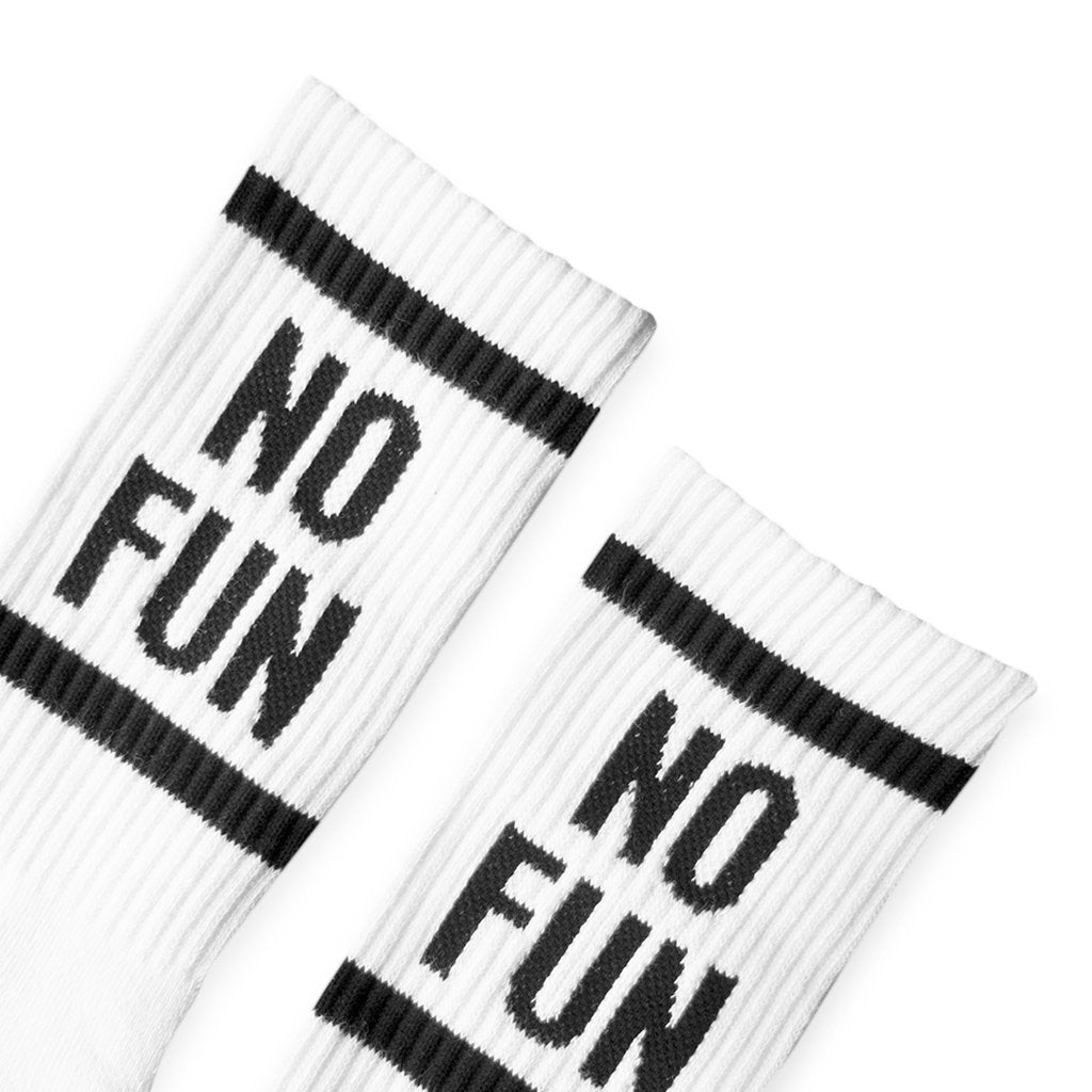 Detail photo of our signature NO FUN® crew socks. 100% Pima cotton, woven in the United States. The socks are white and feature "NO FUN®" logo in black on both the leg, and toe cap of the socks.
