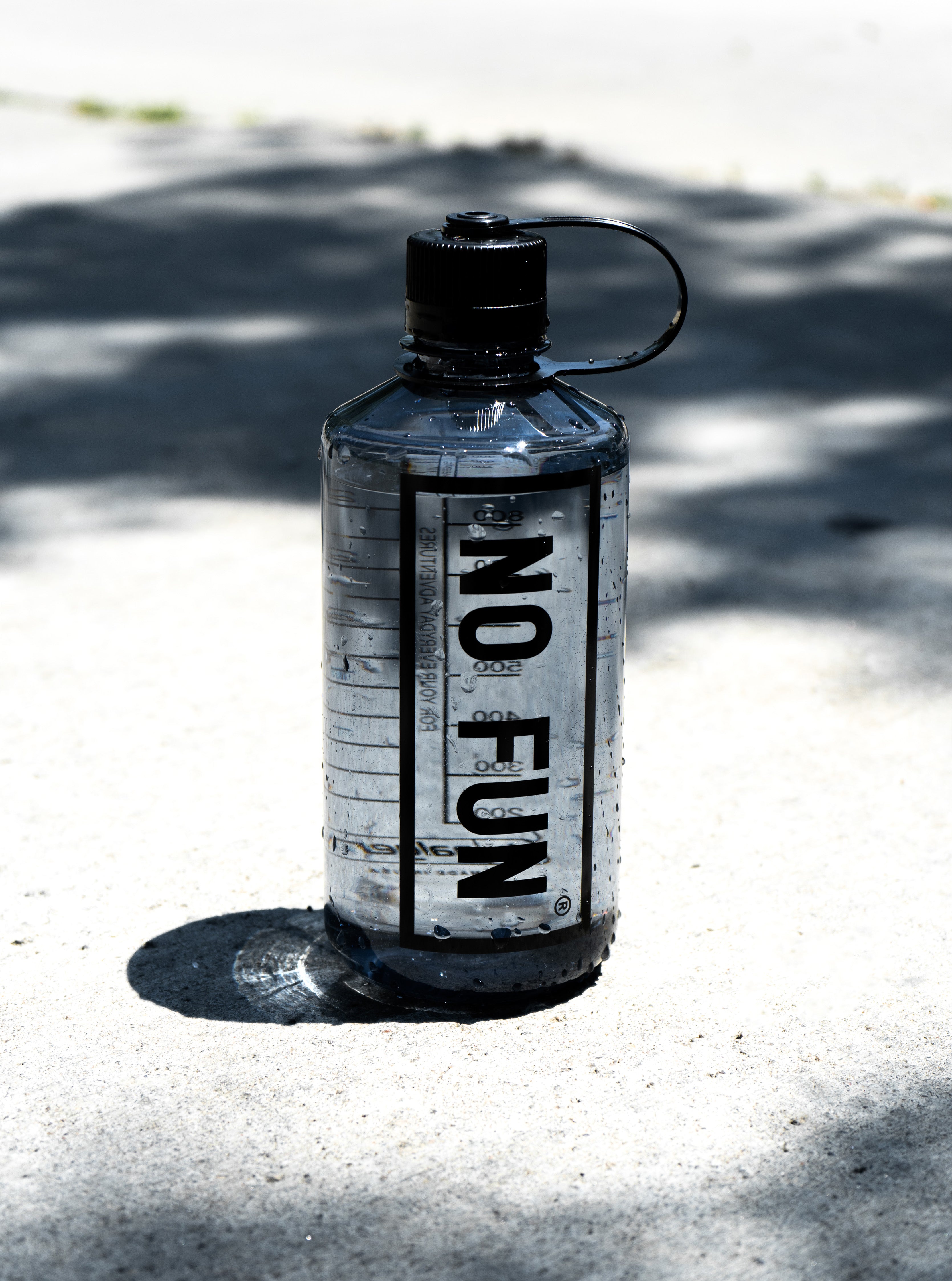 The Nalgene® + No Fun® 32oz narrow mouth bottle. Bottle is grey, with a black lid. There is a large "No Fun®" logo in black on the front. 