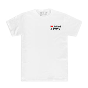 The original "Aging & Dying" T-shirt by No Fun®. T-shirt is white, and is photographed against a white background. The left chest print text reads "I ❤️ Aging & Dying" and is located on the front of the T-shirt. The text is black, with a red heart.