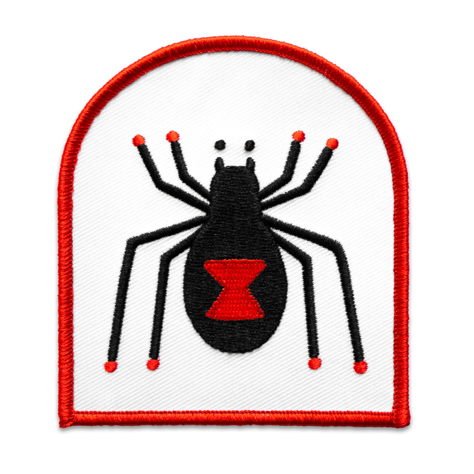 The "Black Widow" Patch by No Fun®.  Patch is white, with a read boarder in the shape of a tombstone. There is a cartoon Black Widow spider design in the center of the patch.  