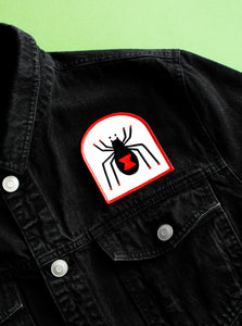The "Black Widow" Patch by No Fun® on a black denim jacket.