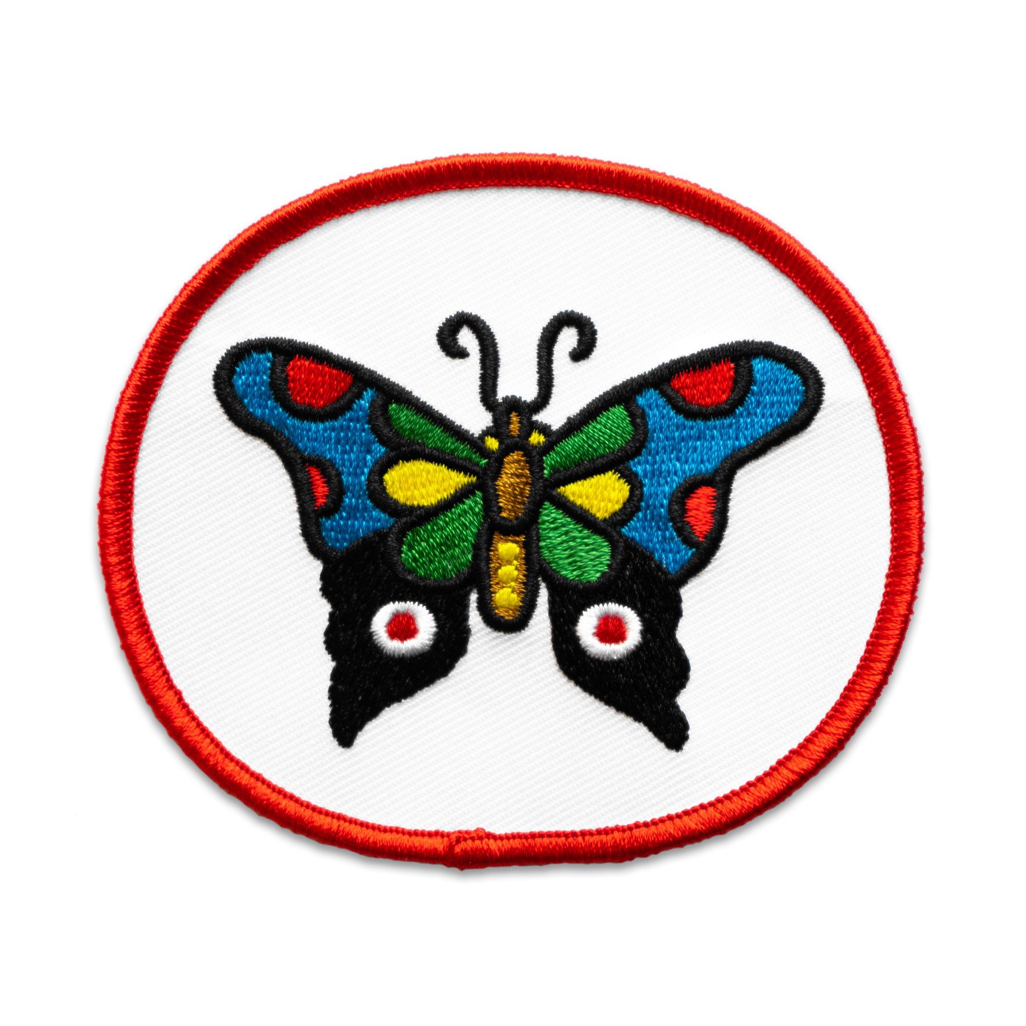 "Butterfly" Patch by No Fun®.  The patch is white with a red edge, in an oval shape.  There is a multi coloured butterfly in the center.