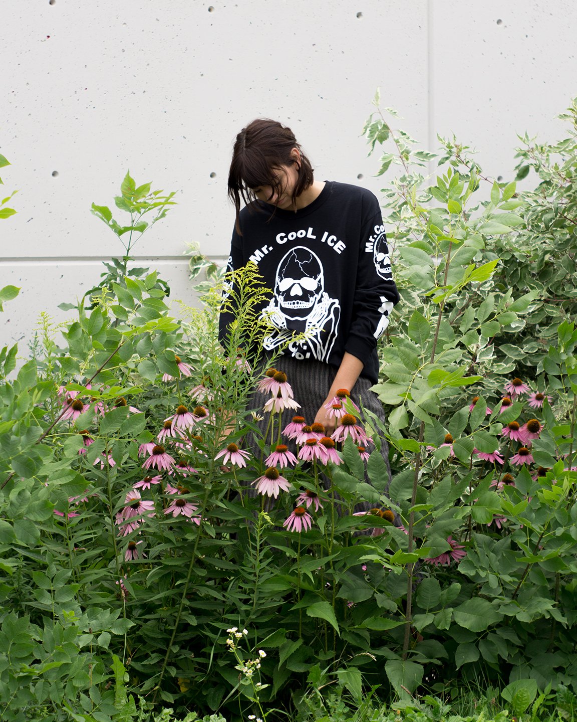 The No Fun® "Mr. Cool Ice" longsleeve shirt worn by a young woman, standing in a garden.