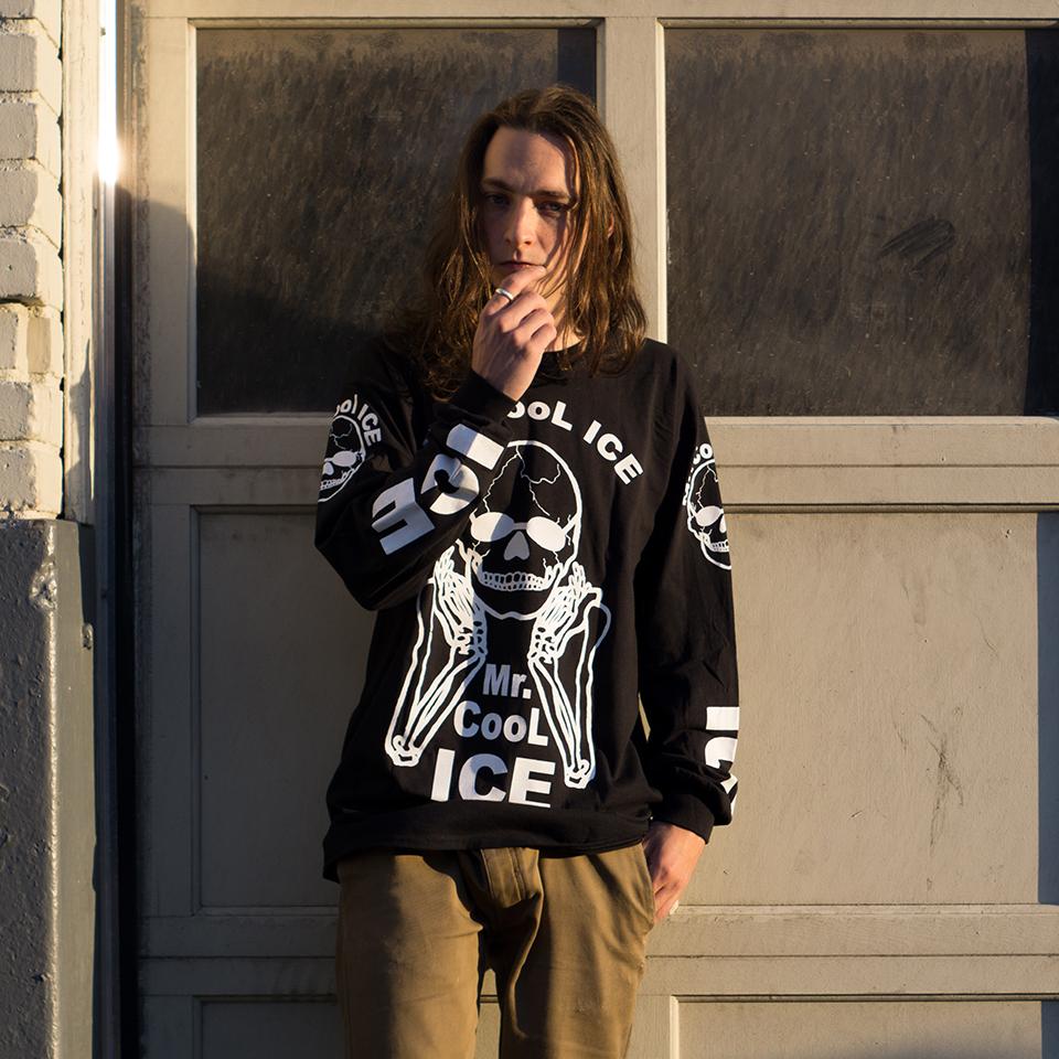 The No Fun® "Mr. Cool Ice" longsleeve shirt worn by a young man, standing in front of a garage.