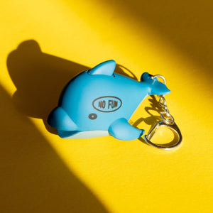 Dolphin keychain that lights up when pressed. No Fun® logo on left side of dolphin.