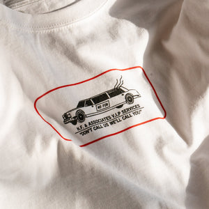 Close up of the "Luxury Services" print on a white t-shirt. 