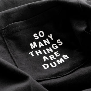Detail of the original NO FUN® "So many things are dumb" pocket tee. This closeup image showcases the front pocket detail, and the white text that reads "So Many Things Are Dumb".