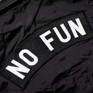 Close up image of the XL "NO FUN®" X "Crawling Death" collaboration coaches jacket.  The patch is black with embroidered black border, and large "NO FUN®" Logo.