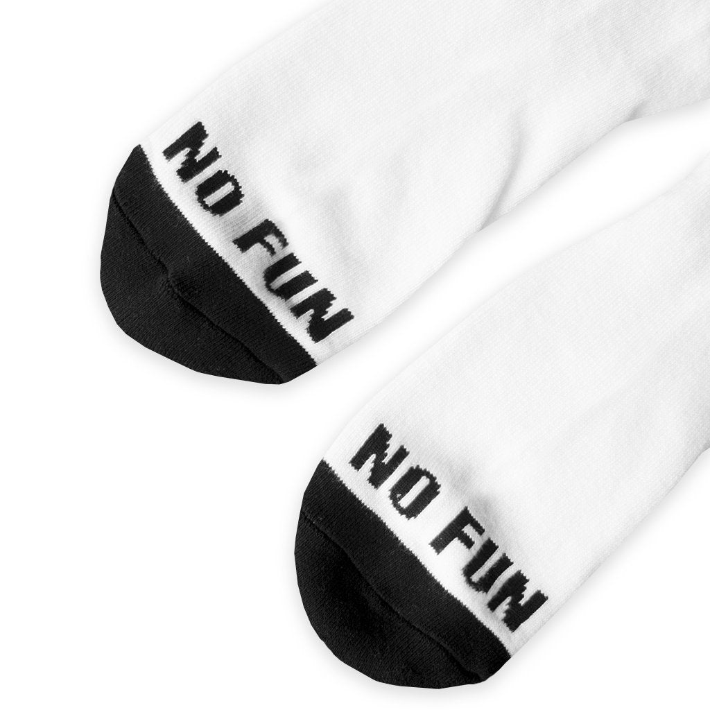 Detail of the toes on the "No Fun" socks. No Fun® logo woven in black across toes, with black toe-cap at end of socks.
