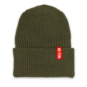 Photo of the "No Fun®" Ribbed beanie photographed against a white background.  Beanie is Olive Drab coloured, and features a small, red, woven label that folds over the cuff.  The text on the red label says "No Fun®" in white.
