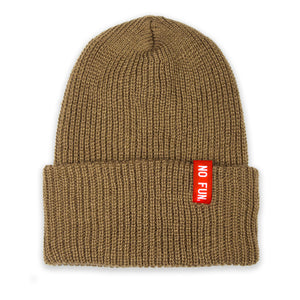 Photo of the "No Fun®" Ribbed beanie photographed against a white background.  Beanie is Desert Tan coloured, and features a small, red, woven label that folds over the cuff.  The text on the red label says "No Fun®" in white.