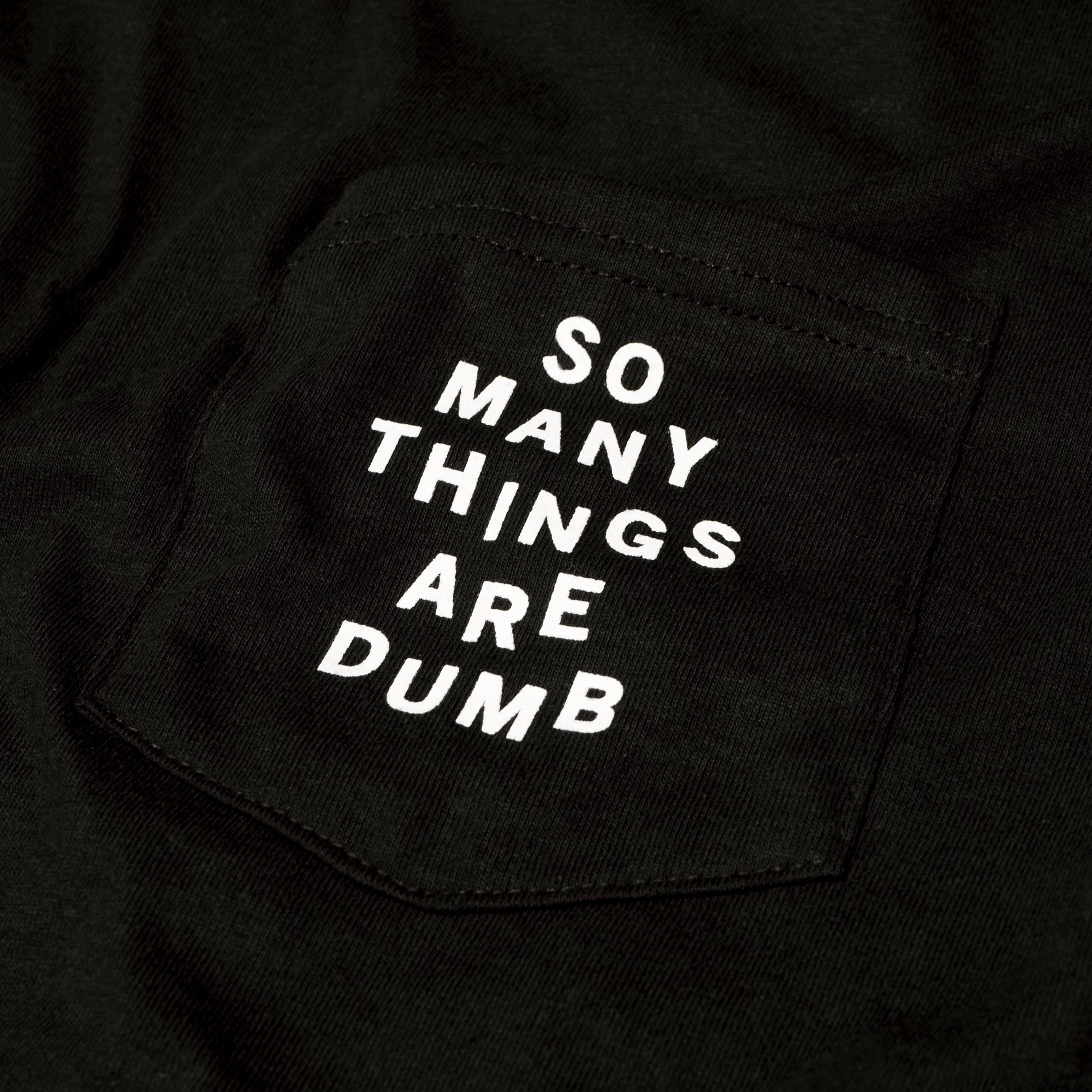 Detail of the original NO FUN® "So many things are dumb" pocket tee.  This closeup image showcases the front pocket detail, and the white text that reads "So Many Things Are Dumb".