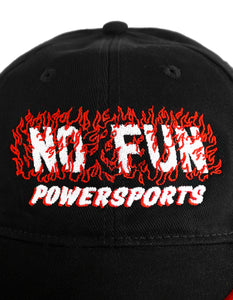 The "Speed" Hat in Tar Black by No Fun®. The baseball style hat is black, with a black, white, and red checkerboard detail on the brim. The text "No Fun® Powersports" is embroidered on the front in white, surrounded by red embroidery flames.  Photo shows the embroidery close up.