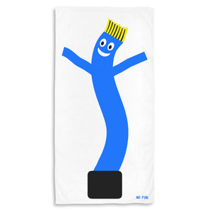 The "Wacky Wavy" Beach Towel by No Fun®. The towel is white, and features a large, blue, "Wacky Waving" tube man graphic. The tube man has yellow hair, and a smily face. There is a small, blue, No Fun® logo in the bottom right hand corner of the towel.
