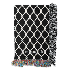 The original "Chainlink" Woven Blanket from No Fun®.  Woven blanket is black, with white chainlink design and is photographed folded against a white background.  There is a small "No Fun®" logo in the bottom right-hand corner of the blanket which is shown in this image. 