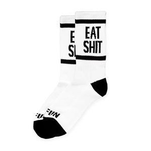 "Eat Shit" Socks by No Fun®.  Crewneck hight socks are white, with black heel and toe cap.  The phrase "Eat Shit" is woven in black into the leg of the sock.  There is a black band found above, and below the "Eat Shit" text.  "No Fun®" is woven in black, just above the black toecap on the top.