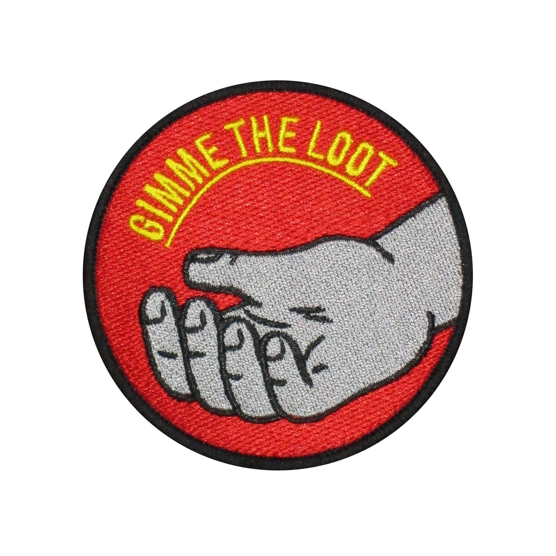 The "Gimme the Loot" embroidered iron-on patch. 3" diameter patch with hand out stretched and text that reads "gimme the loot". Silver hand, yellow text, red background.