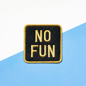 Black and gold "No Fun®" logo patch on a white and blue background.