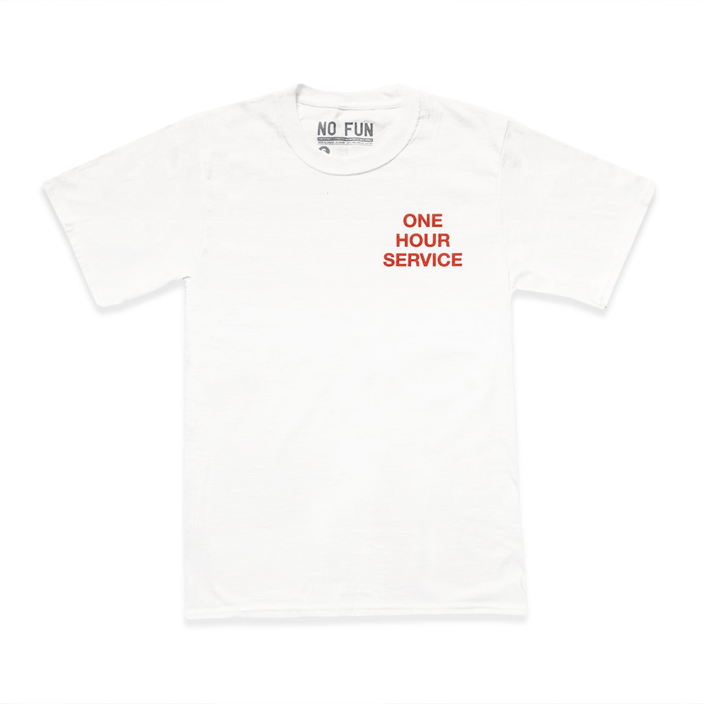 The No Fun Press "One Hour Service" T-Shirt in Day Shift White. Designed and made in Toronto.  T-shirt features red text that reads "ONE HOUR SERVICE" along the breast.