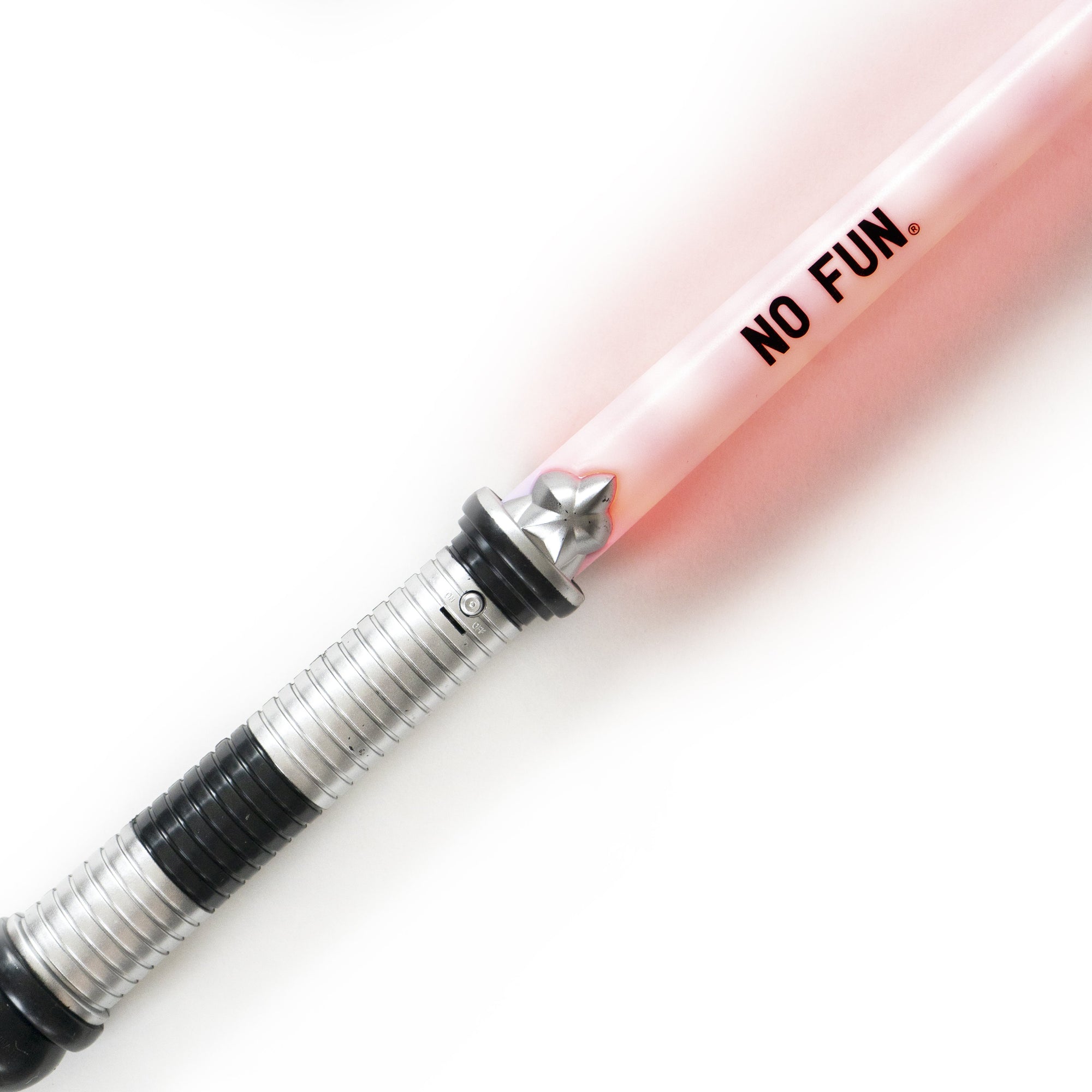 A close up photo of a light up novelty sword glowing red on a white background. Near the handle is a Black "NO FUN®" logo."