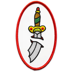 The "Sword" Patch by No Fun®.  Patch is white with a red boarder, in an oval shape.  There is a multi-coloured sword in the center of the oval, that is designed to look as if it has pierced through the center of the patch.