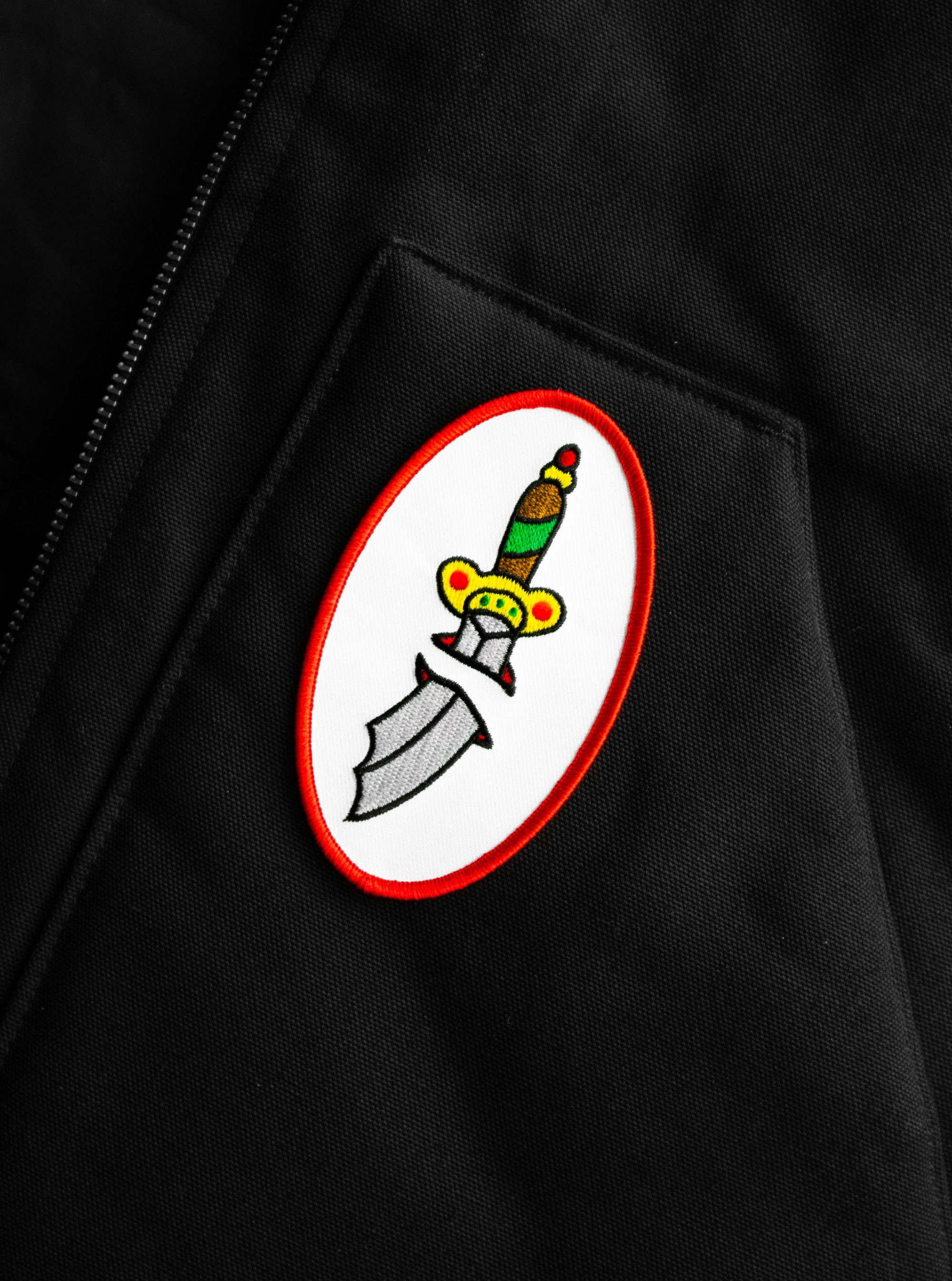 The "Sword" Patch on a black canvas vest.
