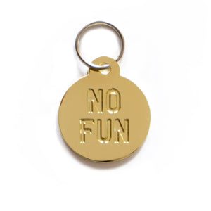 "No Fun®" circular Pet Tag Keyring in bronze. 1.25" diameter molded metal keyring.  Item is photographed against a white background to showcase the brass coloring.
