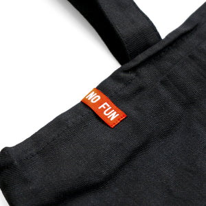 Detail of the red No Fun® logo label on the zippered "Life is Hell" tote bag.